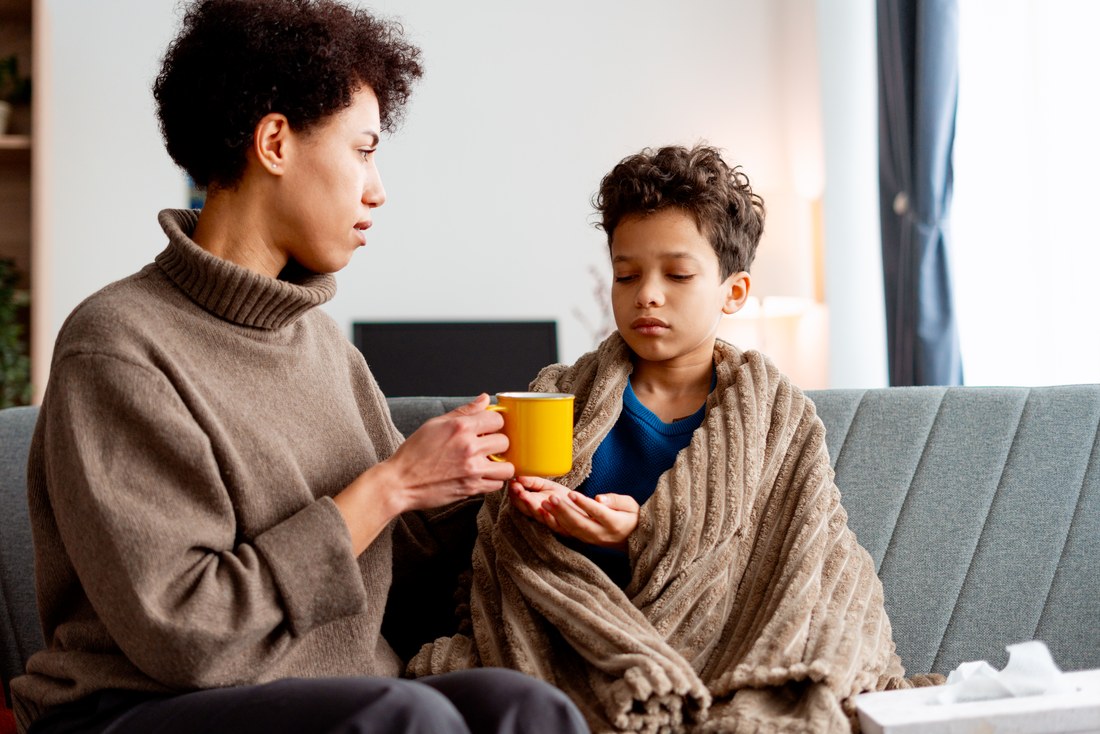 A parent resting with a school-age child.